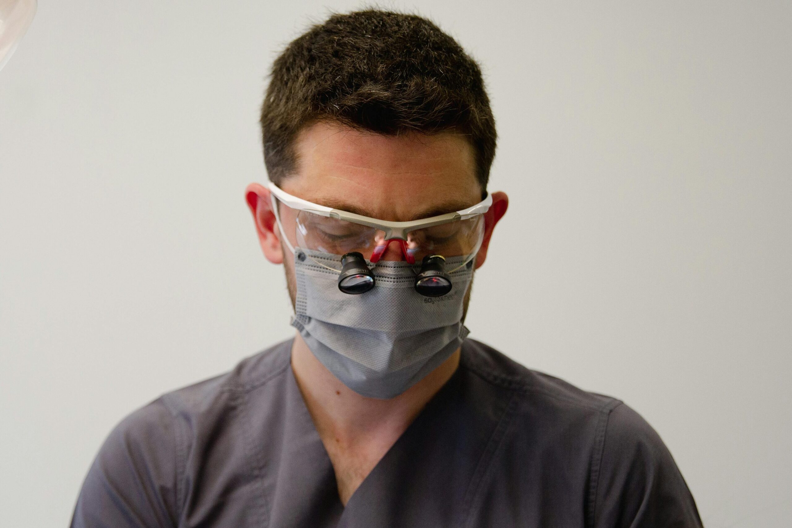pexels-photo-12745979-12745979 A dentist uses professional tools to treat a patient in a well-lit dental office.